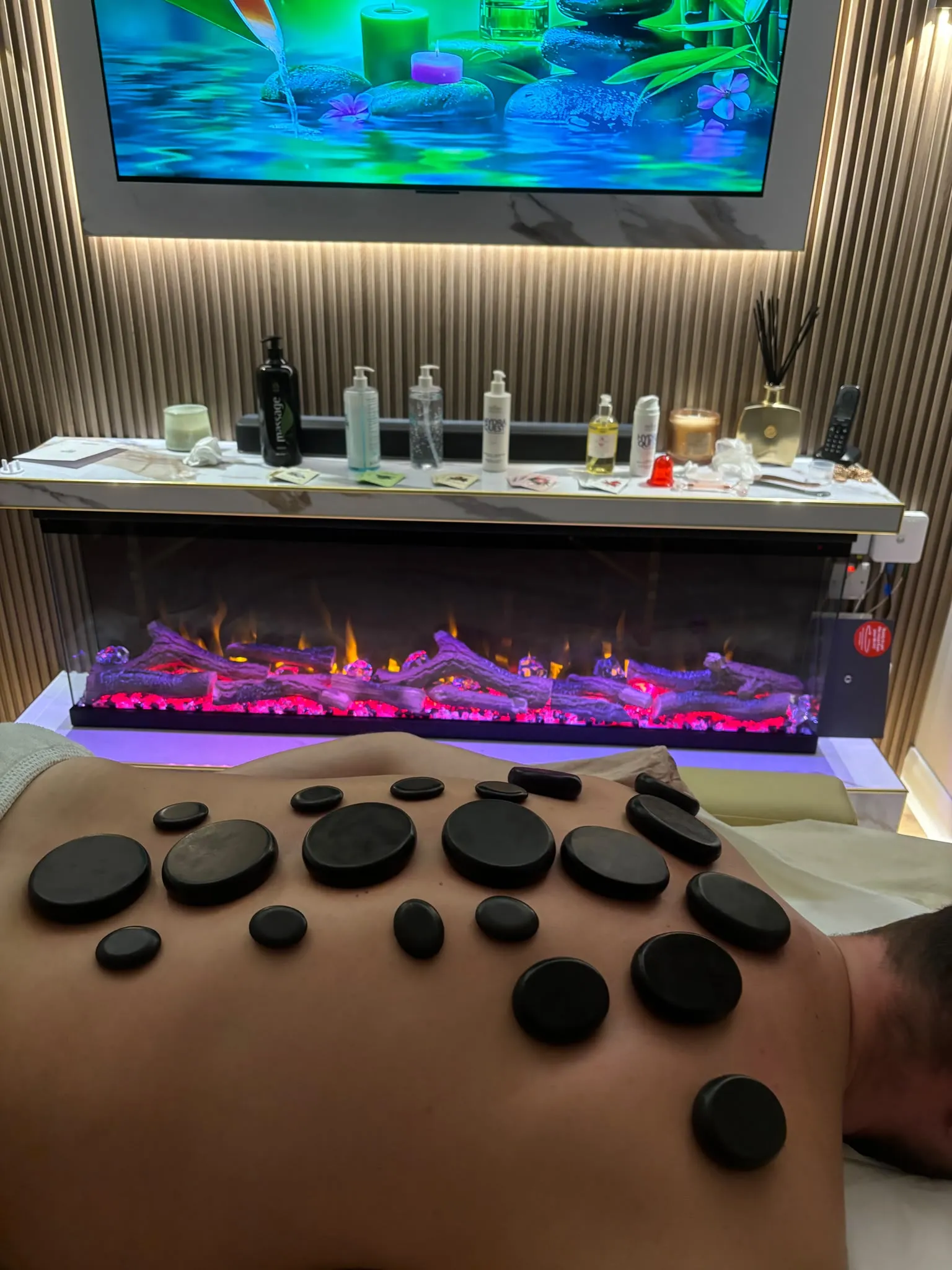 A hot stone massage in a softly lit room
